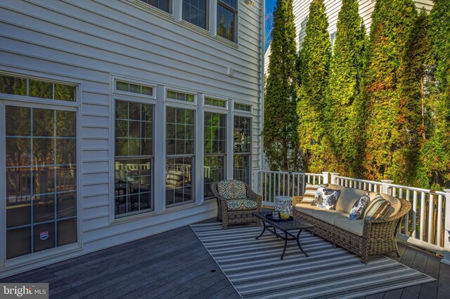 wooden deck with an outdoor living space