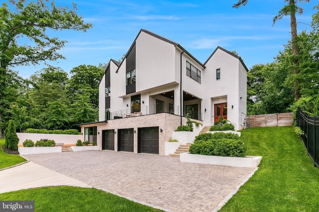 5914 Woodley Rd, Mclean, VA 22101 - view of front of house featuring a balcony, an attached garage, decorative driveway, and stairway