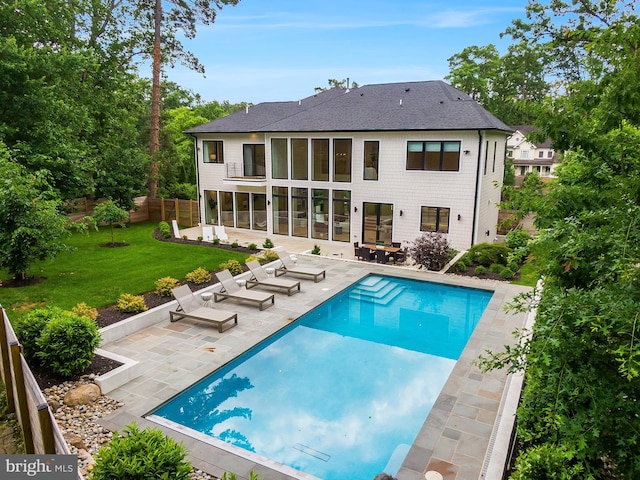 5914 Woodley Rd, Mclean, VA 22101 - rear view of property with a patio, a shingled roof, and an outdoor pool