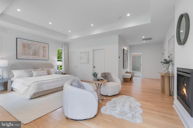 5914 Woodley Rd, Mclean, VA 22101 - bedroom with a raised ceiling, a lit fireplace, light wood-style flooring, recessed lighting, and baseboards