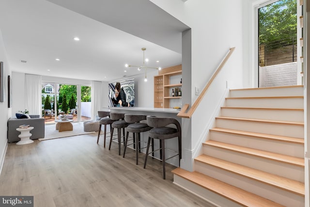 5914 Woodley Rd, Mclean, VA 22101 - kitchen with wood finished floors, recessed lighting, a breakfast bar, open floor plan, and a peninsula