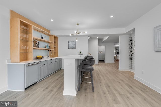 5914 Woodley Rd, Mclean, VA 22101 - kitchen with gray cabinetry, a breakfast bar, open shelves, light countertops, and light wood finished floors