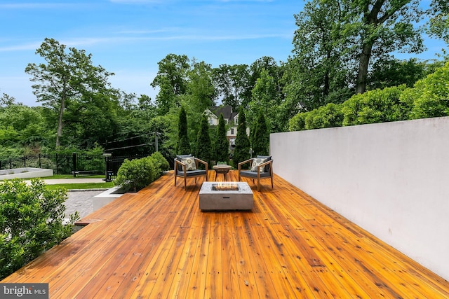 5914 Woodley Rd, Mclean, VA 22101 - wooden terrace with an outdoor fire pit and view of scattered trees