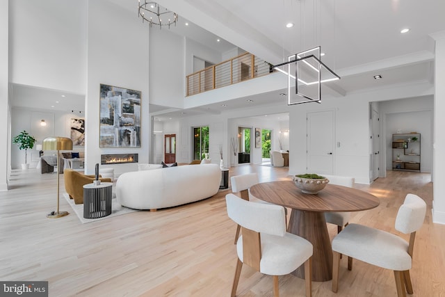 5914 Woodley Rd, Mclean, VA 22101 - dining area with light wood-type flooring, a glass covered fireplace, recessed lighting, and baseboards