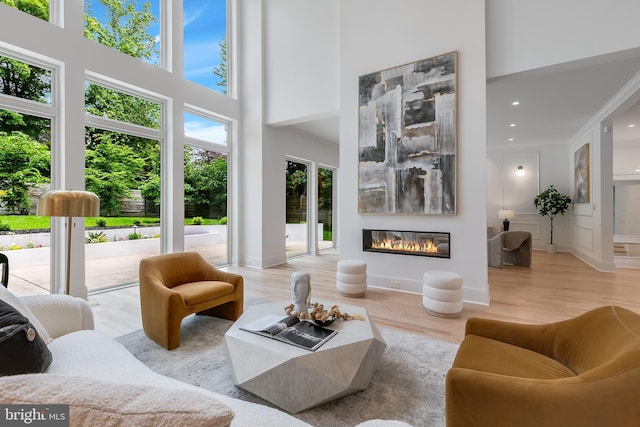 5914 Woodley Rd, Mclean, VA 22101 - living room with a high ceiling, wood finished floors, a glass covered fireplace, and recessed lighting