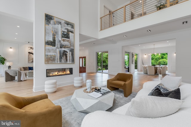 5914 Woodley Rd, Mclean, VA 22101 - living room with wood finished floors, recessed lighting, a decorative wall, a glass covered fireplace, and a high ceiling