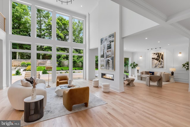 5914 Woodley Rd, Mclean, VA 22101 - living area with a glass covered fireplace, ornamental molding, wood finished floors, and a towering ceiling