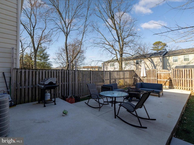 view of patio / terrace featuring an outdoor fire pit, grilling area, fence, central air condition unit, and outdoor dining space