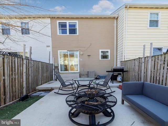 rear view of house with central air condition unit, a patio area, a fenced backyard, and an outdoor living space