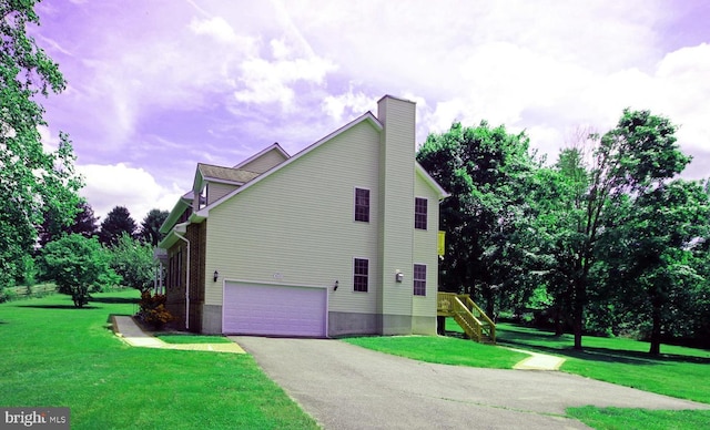 view of property exterior featuring driveway, a yard, a chimney, and a garage