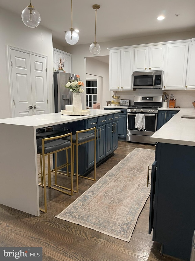 kitchen with appliances with stainless steel finishes, white cabinets, and light countertops