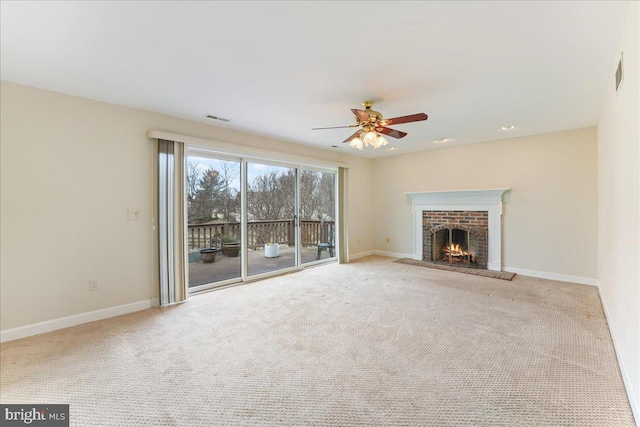 unfurnished living room featuring a brick fireplace, carpet, visible vents, and baseboards