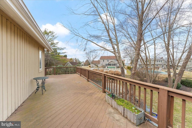 wooden terrace with a residential view