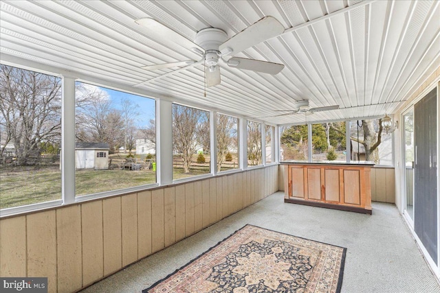 sunroom with a ceiling fan