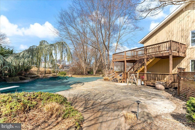 view of swimming pool with a patio area, a covered pool, a deck, and stairs