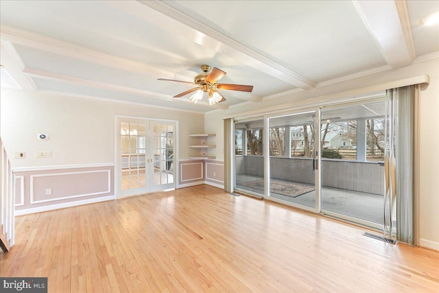 interior space featuring visible vents, a ceiling fan, wood finished floors, french doors, and beam ceiling