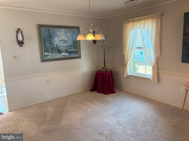 unfurnished dining area with a chandelier, carpet, wainscoting, and wallpapered walls