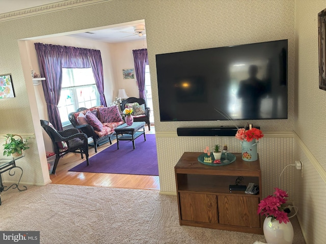 living room featuring light wood-type flooring, light colored carpet, and wallpapered walls