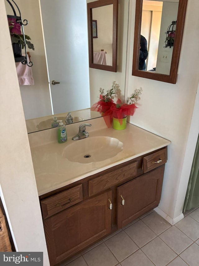 bathroom featuring tile patterned flooring and vanity