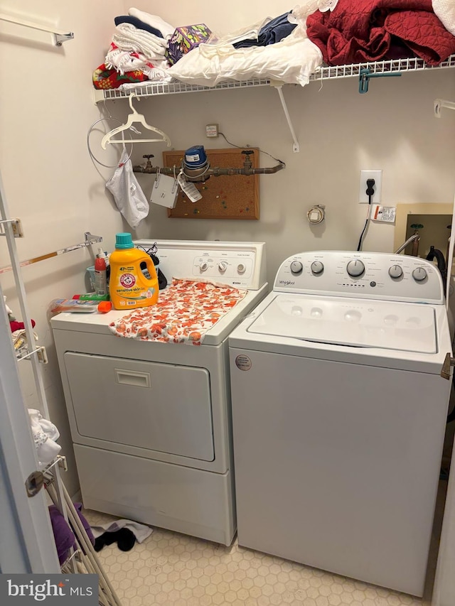 clothes washing area featuring laundry area and separate washer and dryer