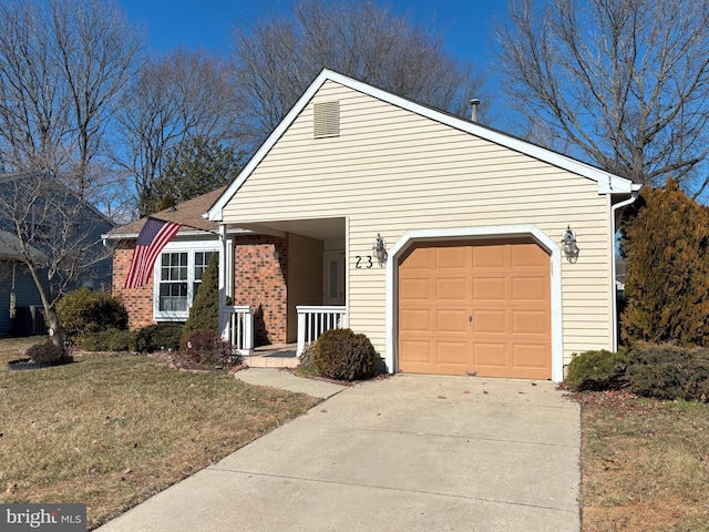 view of front of property featuring driveway, brick siding, a front lawn, and an attached garage