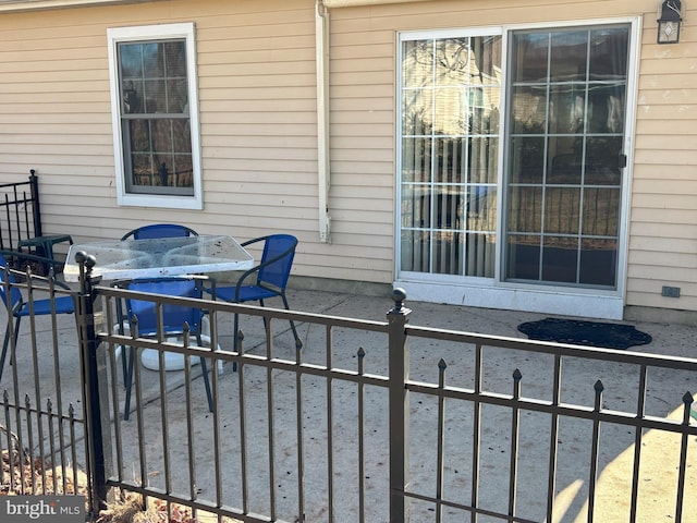 view of patio featuring outdoor dining area and fence