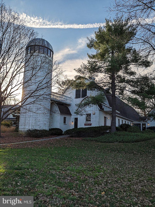 view of side of home with a yard