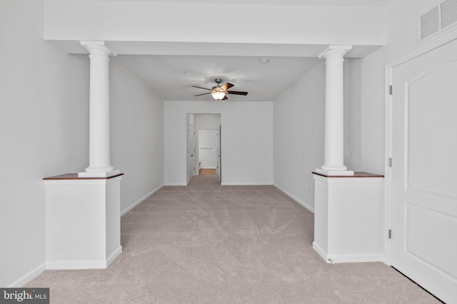 empty room featuring light carpet, visible vents, baseboards, and a ceiling fan