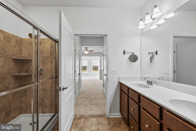 bathroom featuring a shower stall, double vanity, and a sink