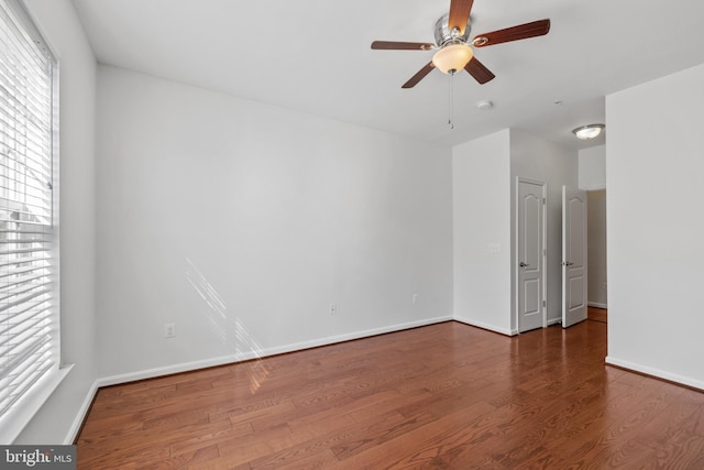 unfurnished room with ceiling fan, baseboards, and wood finished floors