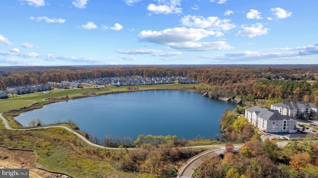 aerial view with a forest view and a water view