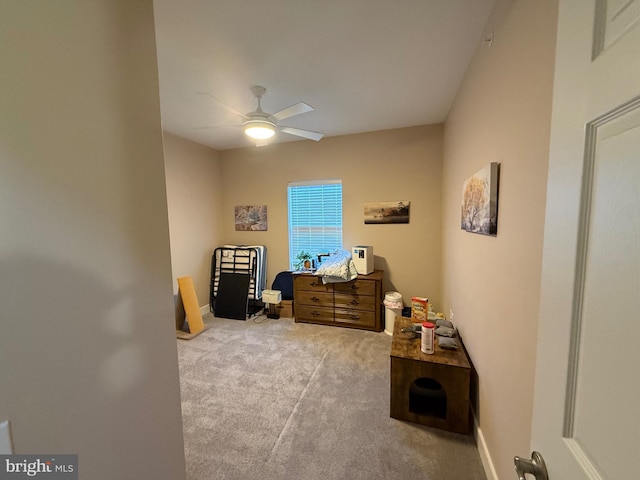 miscellaneous room featuring ceiling fan, baseboards, and light colored carpet