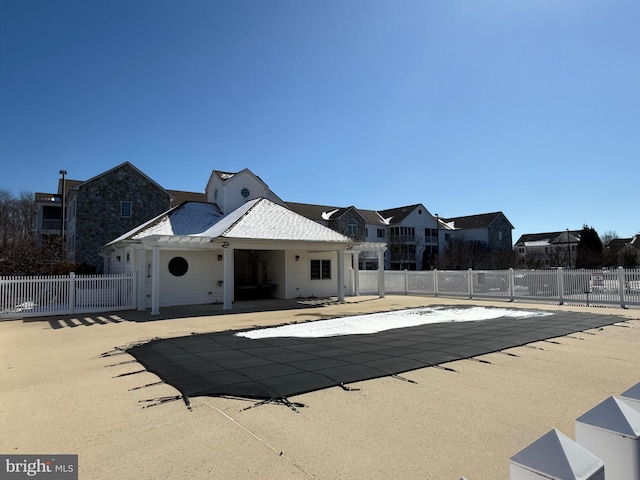 pool with a patio area and fence