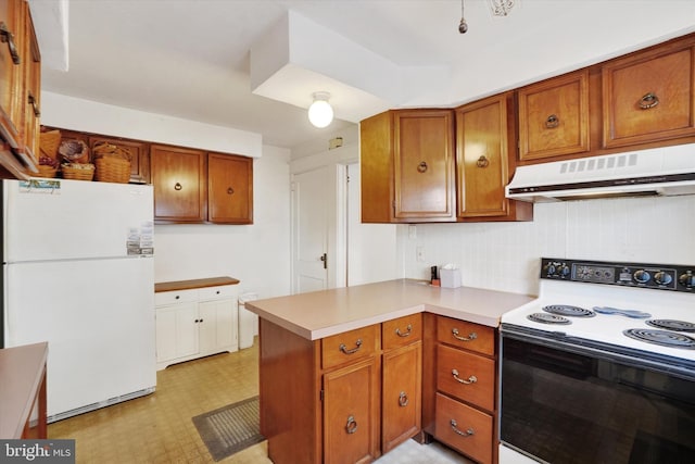 kitchen with under cabinet range hood, freestanding refrigerator, brown cabinets, electric range oven, and light floors