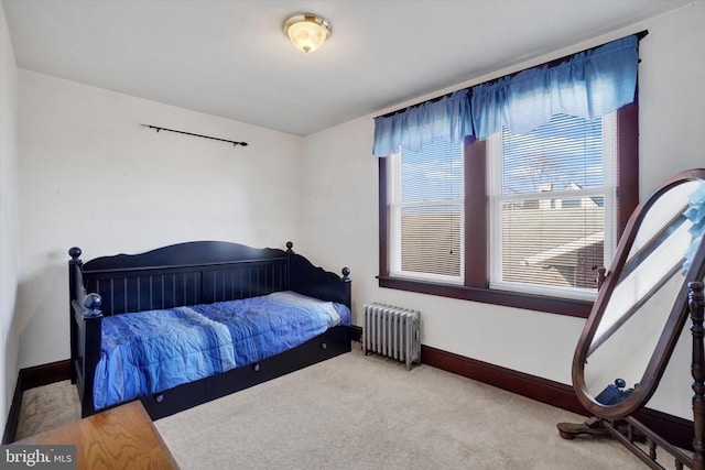 bedroom with carpet, baseboards, and radiator heating unit