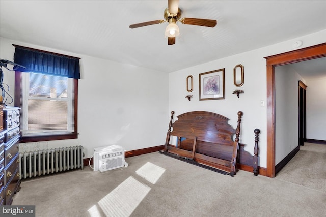 carpeted bedroom featuring baseboards, ceiling fan, and radiator heating unit