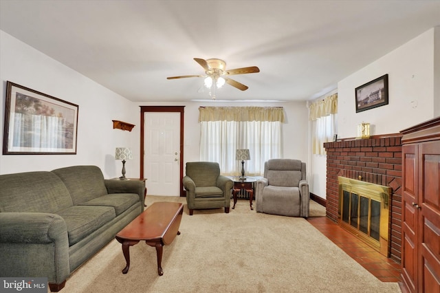 living room featuring a brick fireplace and a ceiling fan