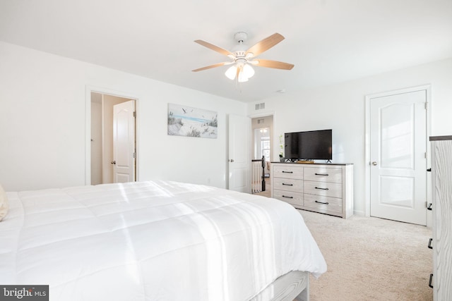 carpeted bedroom featuring a ceiling fan and visible vents