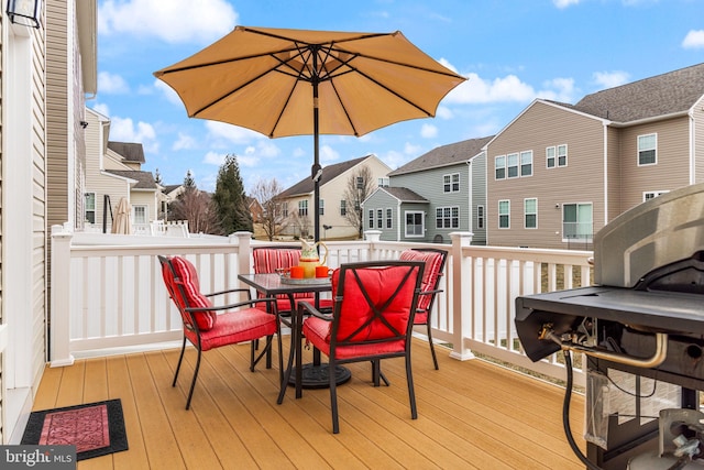 deck featuring a residential view and outdoor dining area