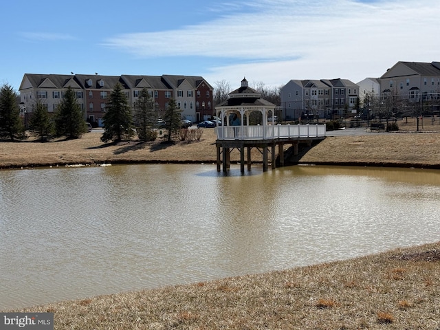 view of water feature with a residential view and a gazebo