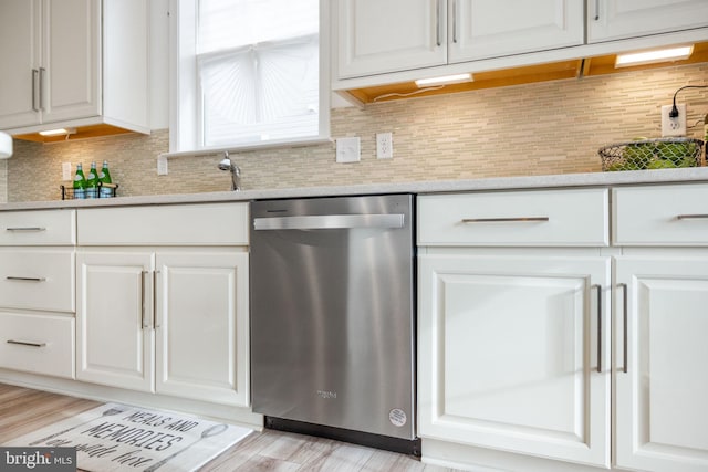 kitchen featuring dishwasher, backsplash, and white cabinets