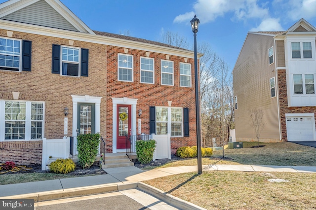 townhome / multi-family property featuring brick siding