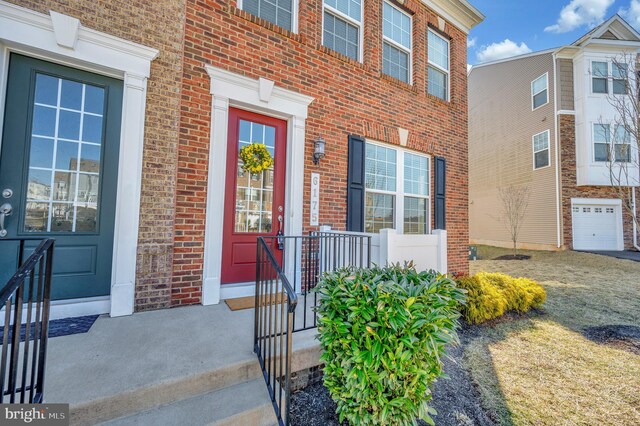 property entrance featuring brick siding