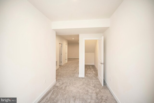 interior space with light carpet and baseboards