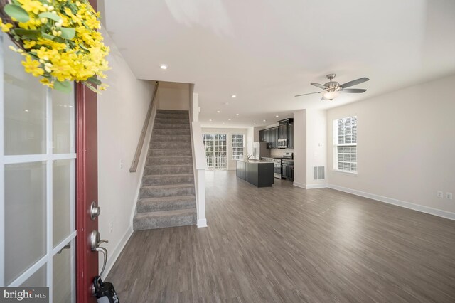 interior space with recessed lighting, dark wood-style flooring, visible vents, baseboards, and stairway