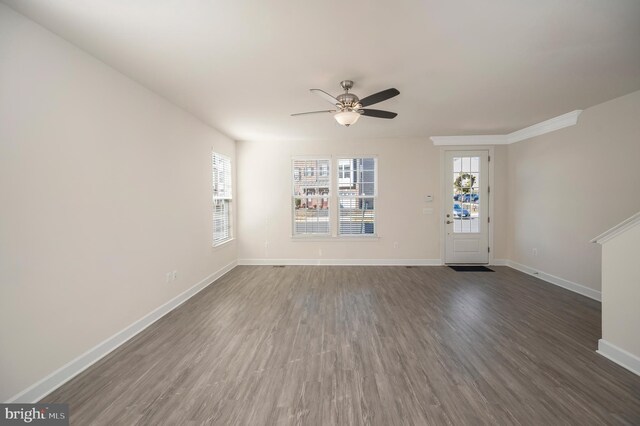 unfurnished living room featuring a ceiling fan, baseboards, and dark wood-style flooring