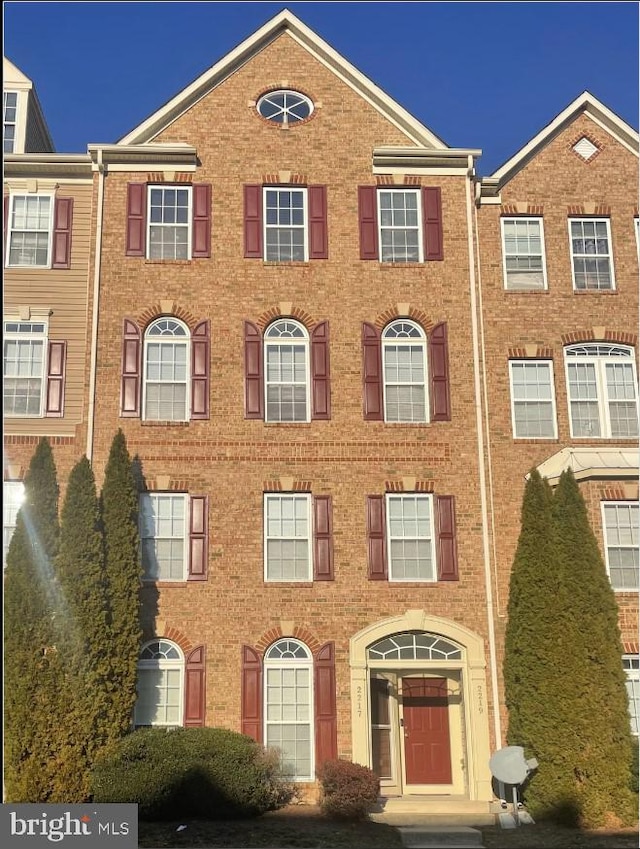 townhome / multi-family property featuring brick siding