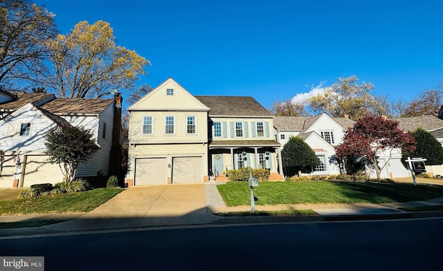 view of front facade with a garage, a front yard, and driveway