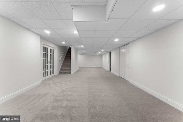 finished below grade area with recessed lighting, light carpet, stairway, and baseboards