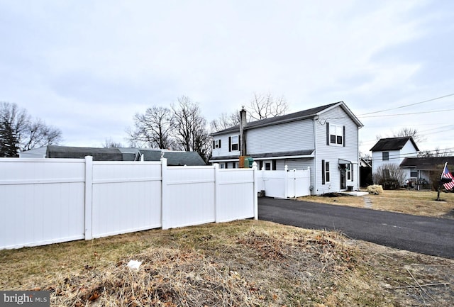 view of home's exterior featuring fence